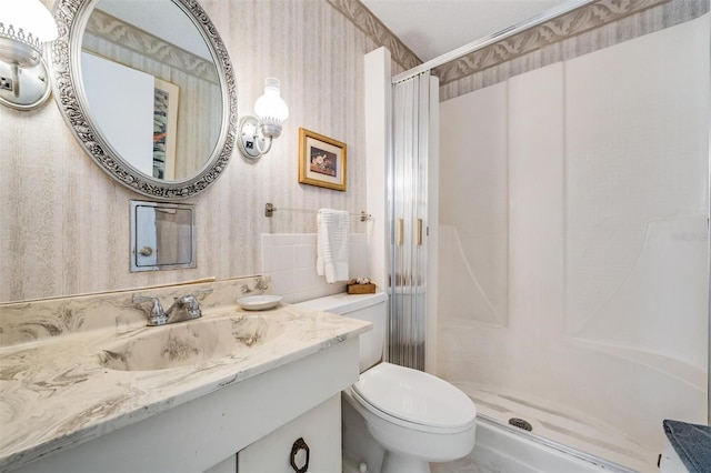 bathroom with vanity, toilet, and walk in shower