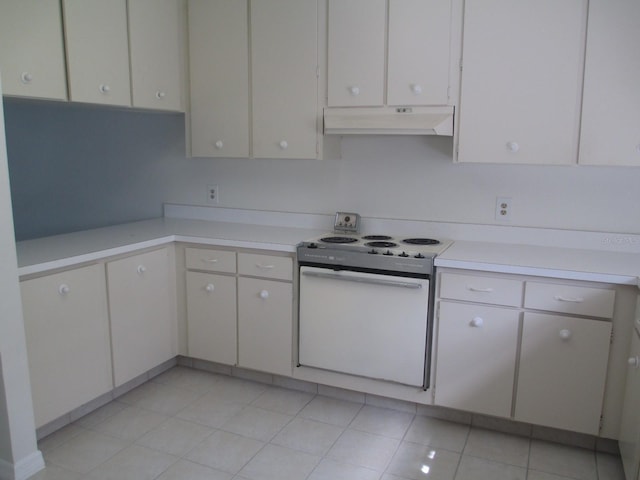 kitchen with white cabinetry, white electric range, and light tile patterned flooring