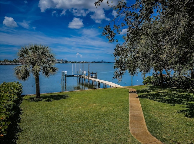 dock area featuring a water view and a lawn