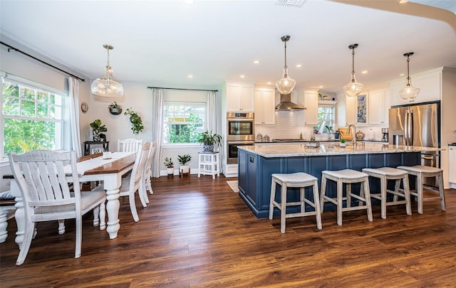 kitchen featuring white cabinets, plenty of natural light, and dark hardwood / wood-style flooring