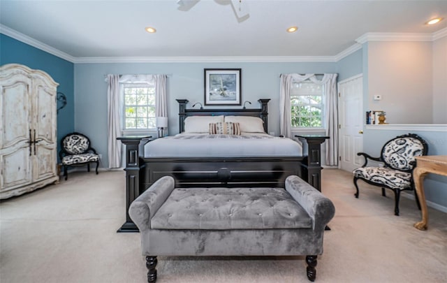 bedroom with ceiling fan, light carpet, and ornamental molding