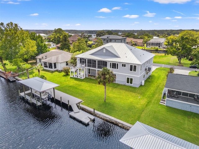 drone / aerial view with a water view and a residential view