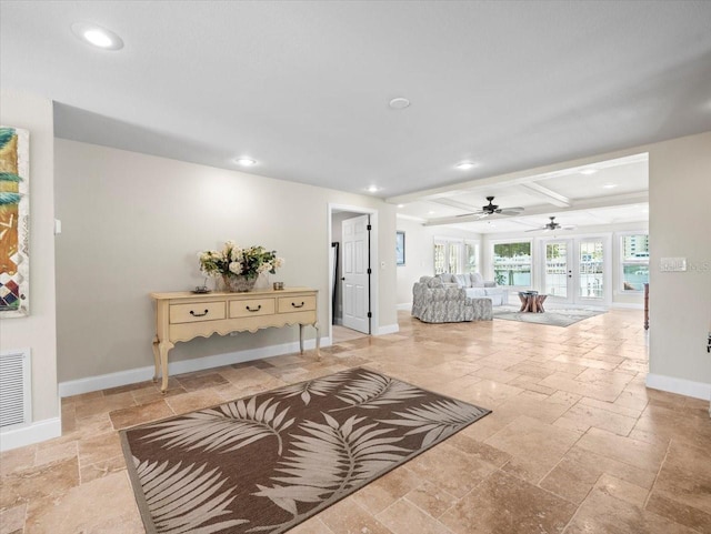 living room featuring coffered ceiling and beamed ceiling