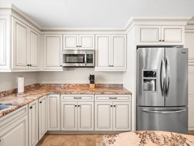 kitchen featuring appliances with stainless steel finishes and light stone counters