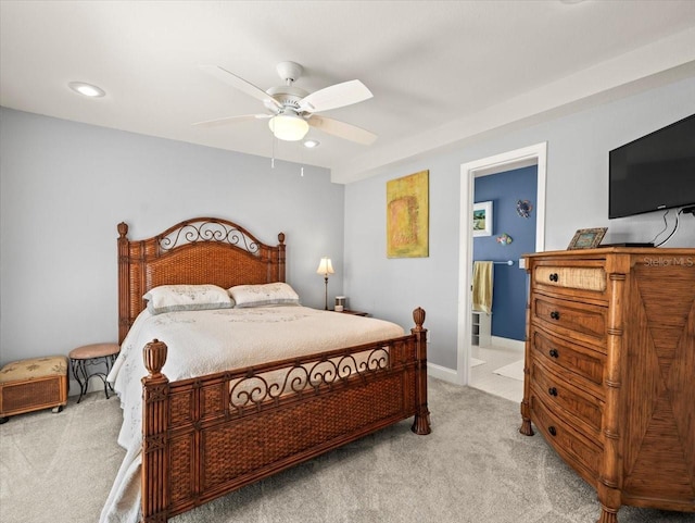 carpeted bedroom with ceiling fan and ensuite bathroom