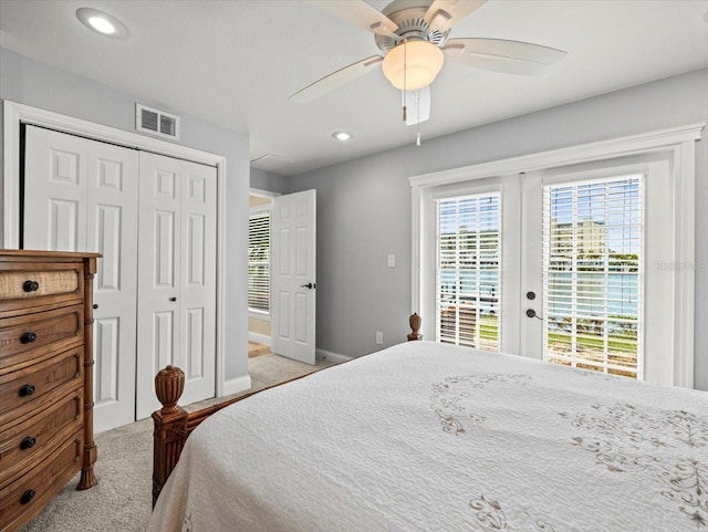 carpeted bedroom with ceiling fan, a closet, and access to outside