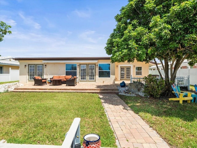 back of house featuring french doors, an outdoor hangout area, a yard, and a patio area