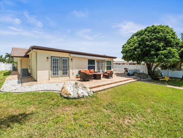 rear view of property with central AC, a lawn, and a patio