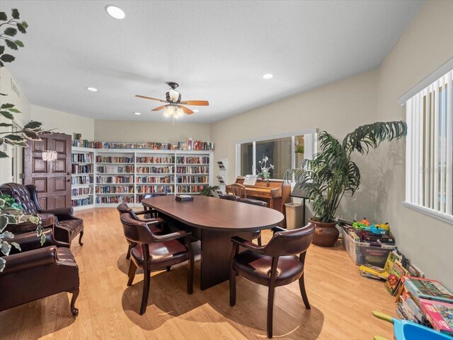 dining space featuring light wood-type flooring, a healthy amount of sunlight, and ceiling fan