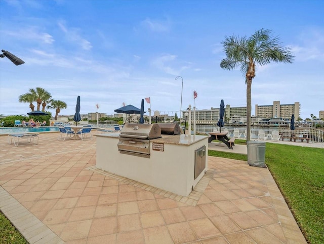 view of patio featuring a grill, a community pool, and area for grilling