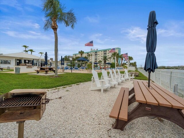 view of community featuring a yard and a patio