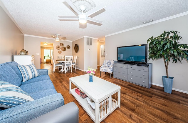 living room featuring ceiling fan, dark wood-type flooring, and crown molding