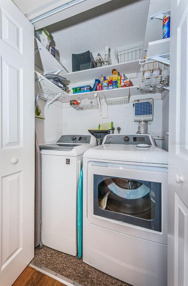 laundry room with hardwood / wood-style flooring and independent washer and dryer