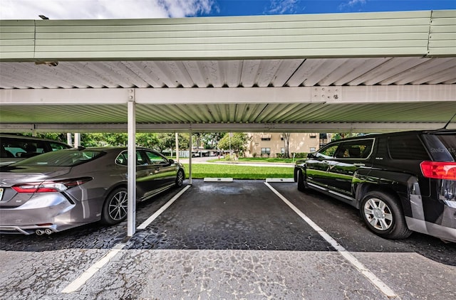 view of vehicle parking with a yard and a carport