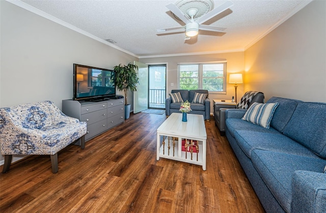 living room featuring ceiling fan, hardwood / wood-style flooring, crown molding, and a textured ceiling