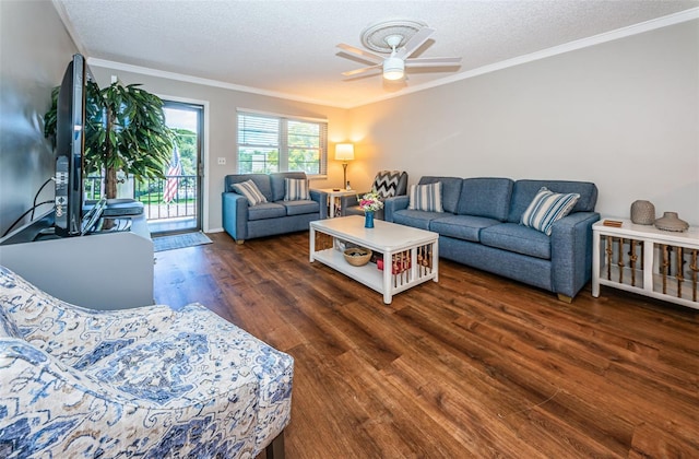 living room featuring a textured ceiling, ceiling fan, ornamental molding, and dark hardwood / wood-style floors