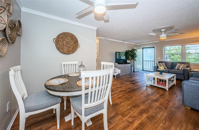 dining space featuring a textured ceiling, ceiling fan, dark hardwood / wood-style flooring, and crown molding