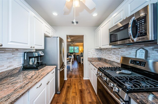 kitchen featuring ceiling fan, stainless steel appliances, dark hardwood / wood-style flooring, and white cabinetry