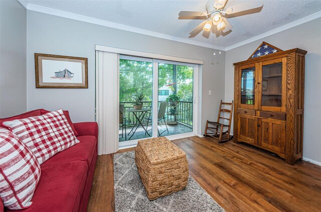 living room with ceiling fan, crown molding, a textured ceiling, and dark hardwood / wood-style floors