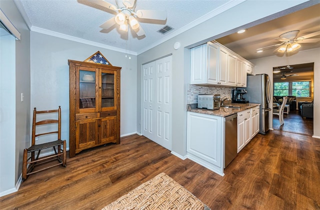 kitchen featuring ceiling fan, dark wood-type flooring, white cabinets, and crown molding