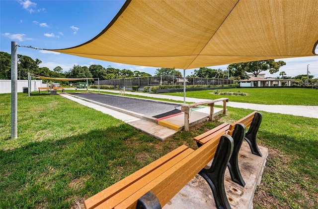 surrounding community featuring a lawn and volleyball court