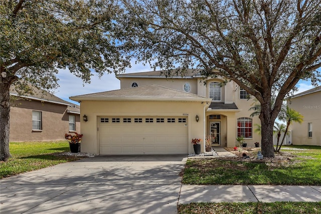 view of front of property featuring a garage and a front lawn