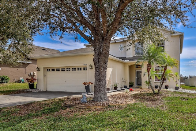 view of front of home with a garage and a front lawn