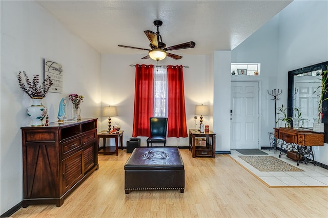 living area with light hardwood / wood-style flooring and ceiling fan