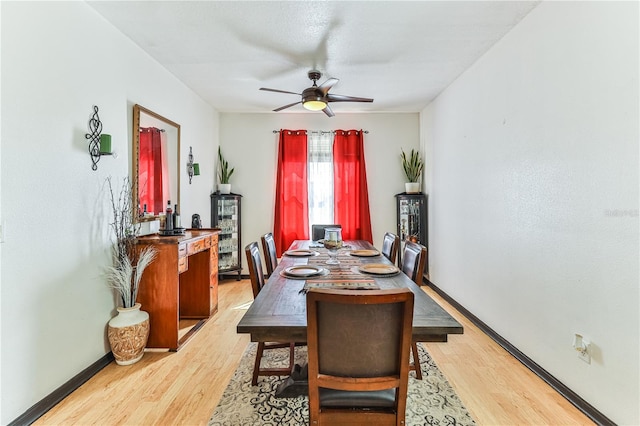 dining area featuring wood-type flooring and ceiling fan