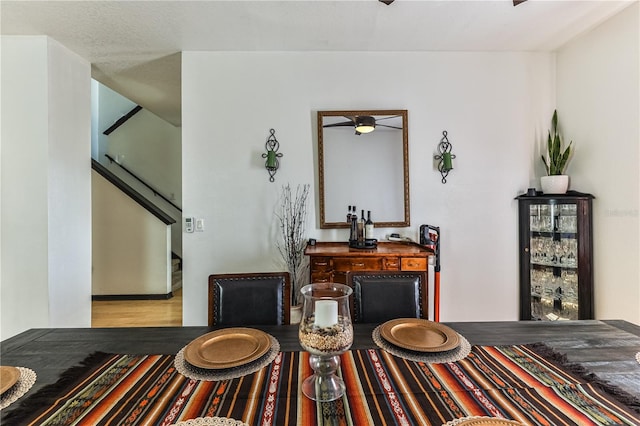 living area with a textured ceiling, hardwood / wood-style floors, and ceiling fan