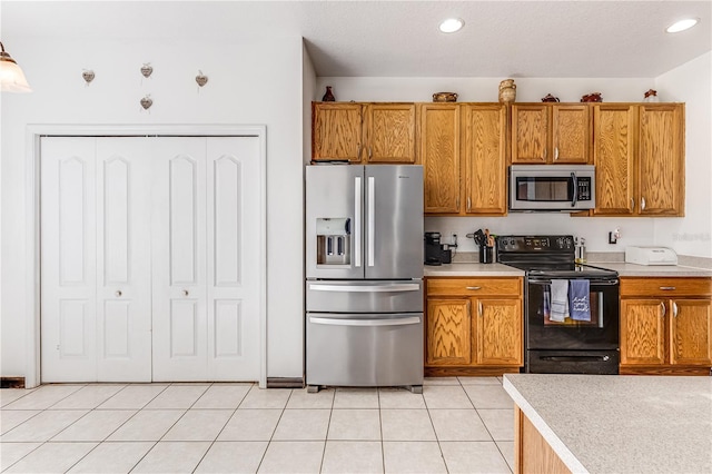 kitchen with light tile patterned flooring and stainless steel appliances