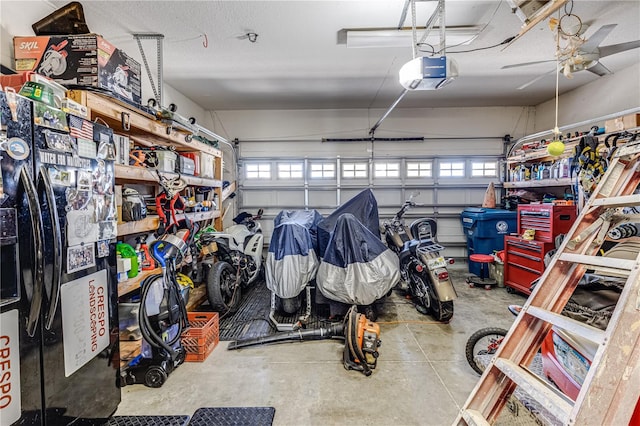 garage with a garage door opener and ceiling fan