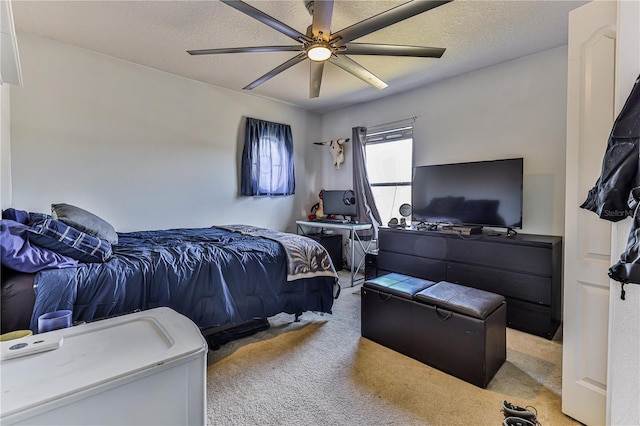 carpeted bedroom featuring ceiling fan and a textured ceiling