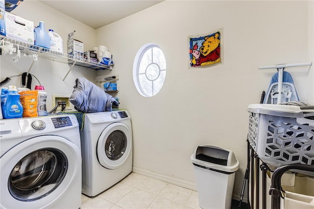 laundry area with light tile patterned floors and washer and dryer