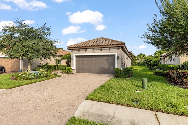 mediterranean / spanish-style home with a front yard and a garage