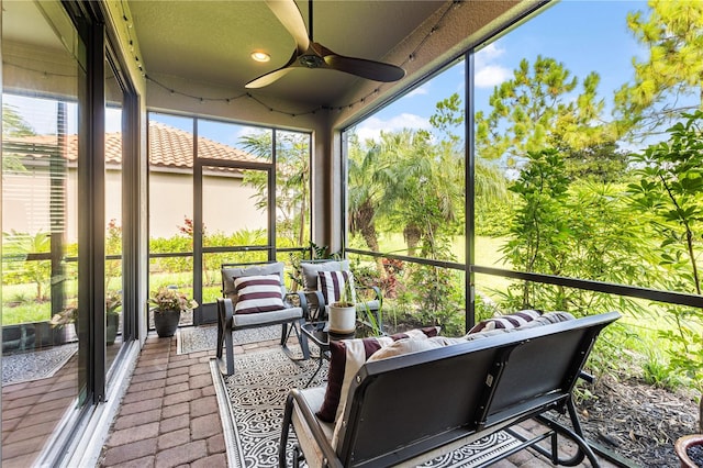 sunroom / solarium with a wealth of natural light and ceiling fan