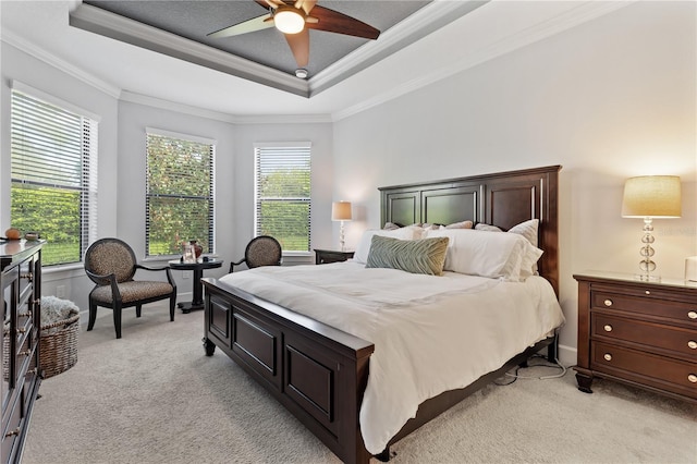 bedroom featuring ceiling fan, ornamental molding, light colored carpet, and multiple windows