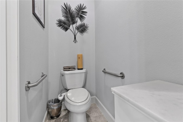 bathroom with toilet and tile patterned floors