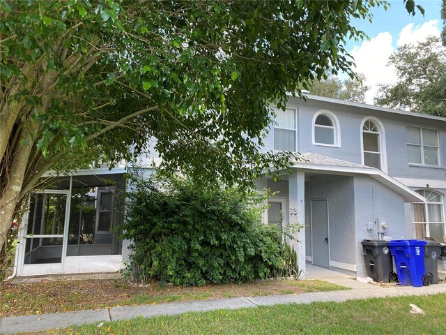 view of home's exterior with a sunroom