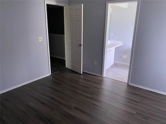 unfurnished bedroom with dark hardwood / wood-style flooring