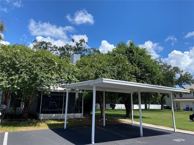 view of car parking with a carport and a yard