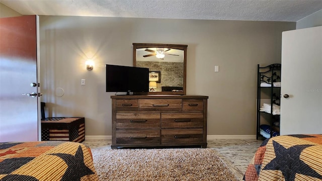 bedroom featuring baseboards and a textured ceiling