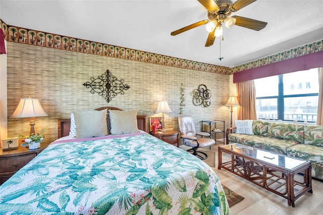 bedroom with ceiling fan and light hardwood / wood-style floors