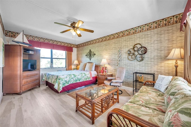 bedroom with ceiling fan and light hardwood / wood-style floors