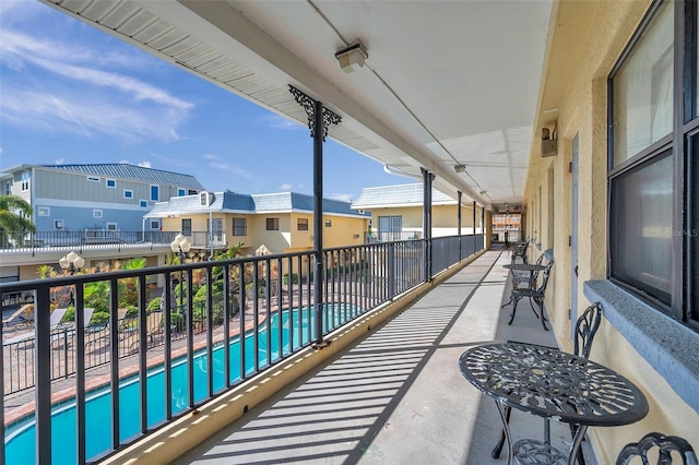 balcony with a fenced in pool