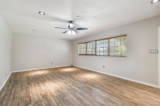 unfurnished room featuring ceiling fan and hardwood / wood-style flooring