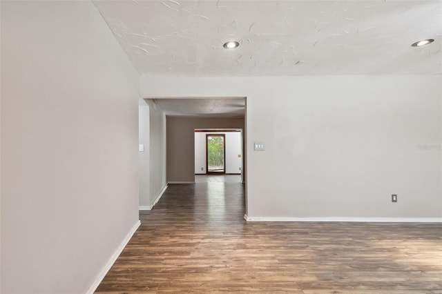 spare room featuring wood-type flooring