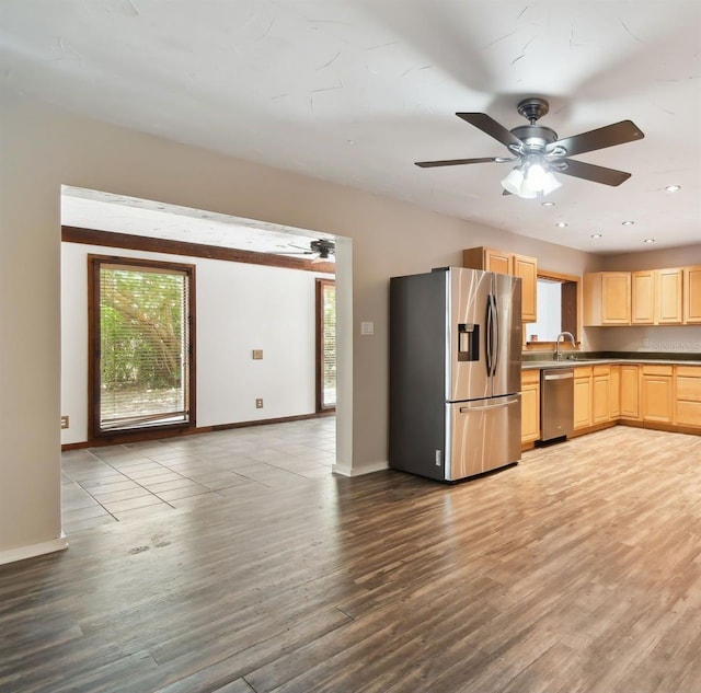 kitchen featuring sink, light wood-type flooring, light brown cabinetry, ceiling fan, and stainless steel appliances