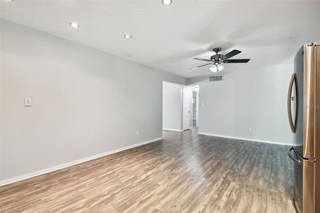 spare room with ceiling fan and light hardwood / wood-style flooring