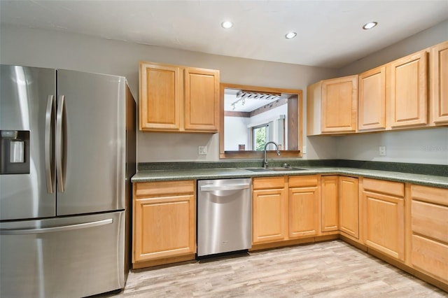 kitchen with light wood-type flooring, sink, stainless steel appliances, and light brown cabinets